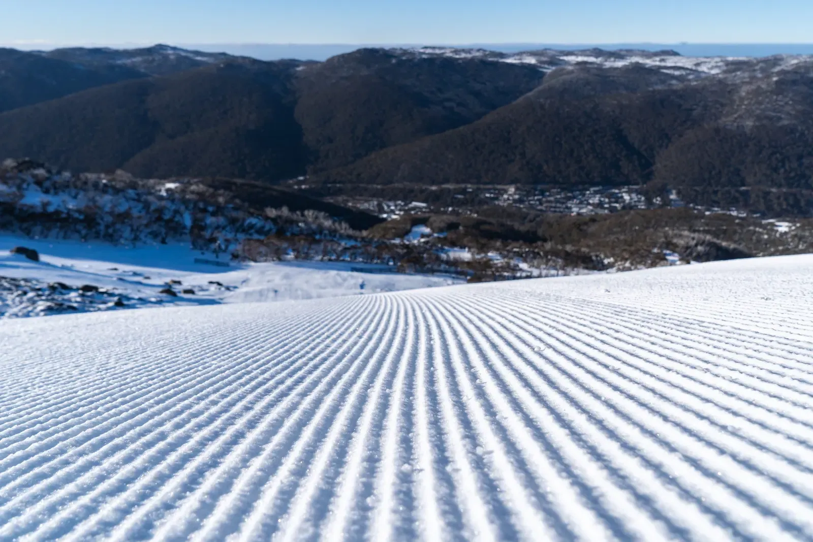 Freshly groomed snow above a mountain valley